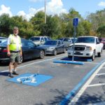 ADA Parking Survey in Florida. Measuring the cross slope of a parking space. Disability Smart Solutions.
