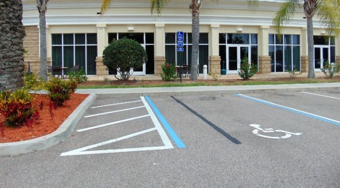 Florida Hotel parking Lot does not have a clear accessible path to the entry. ADA Fail.