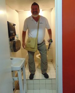 ADA Inspector in a non compliant public restroom. Inspections for ADA Compliance.